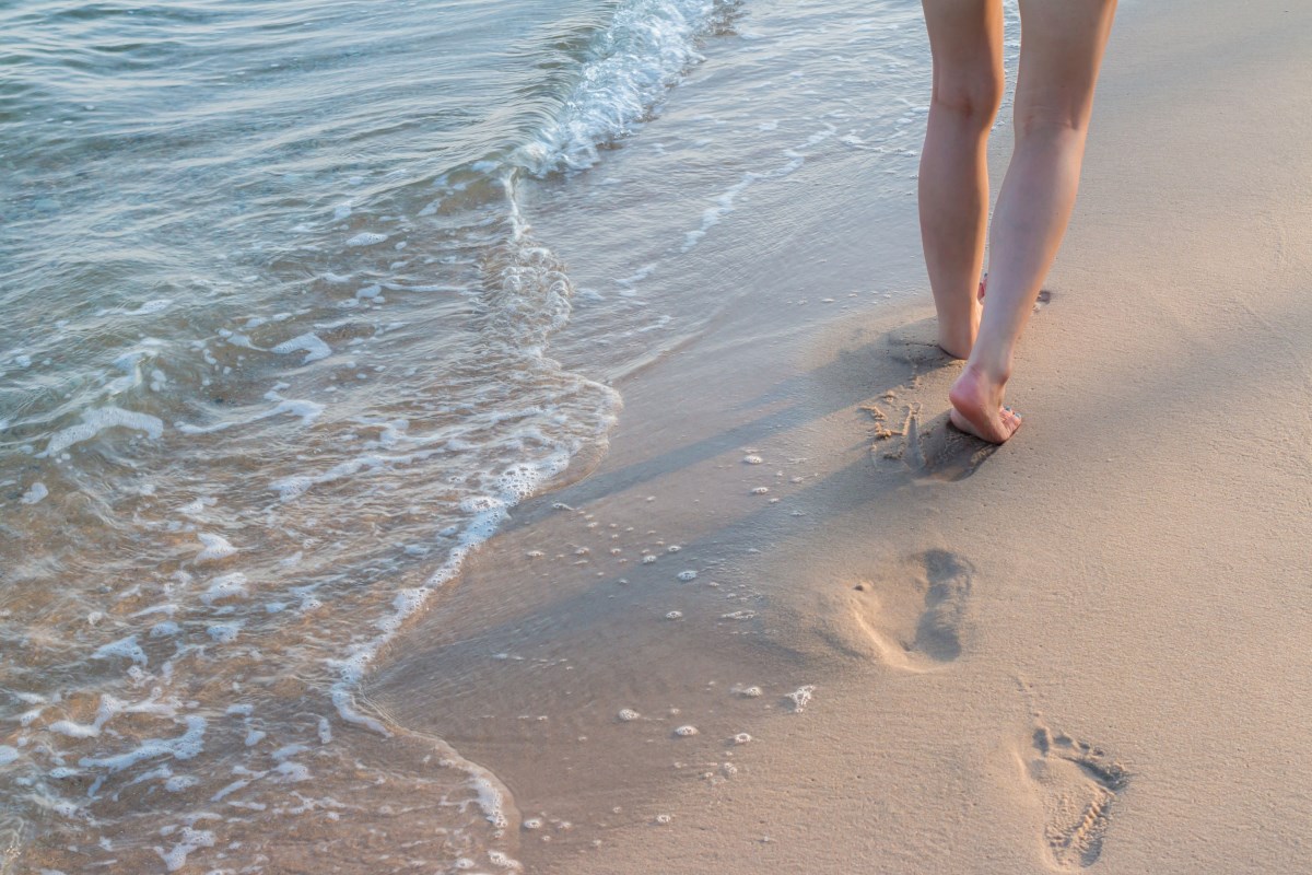 walking alone on sand beach